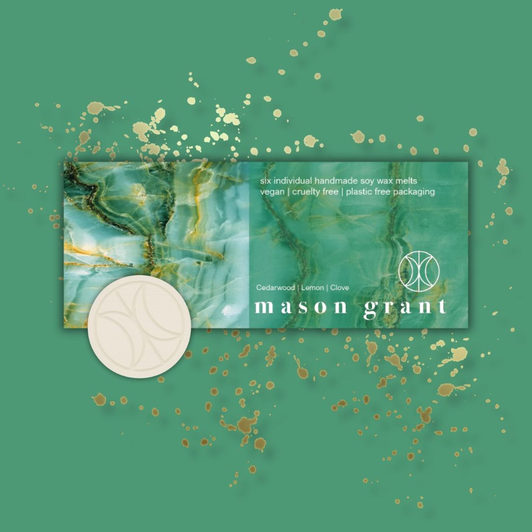 Mason Grant branded packaging with a soy wax melt on a green background