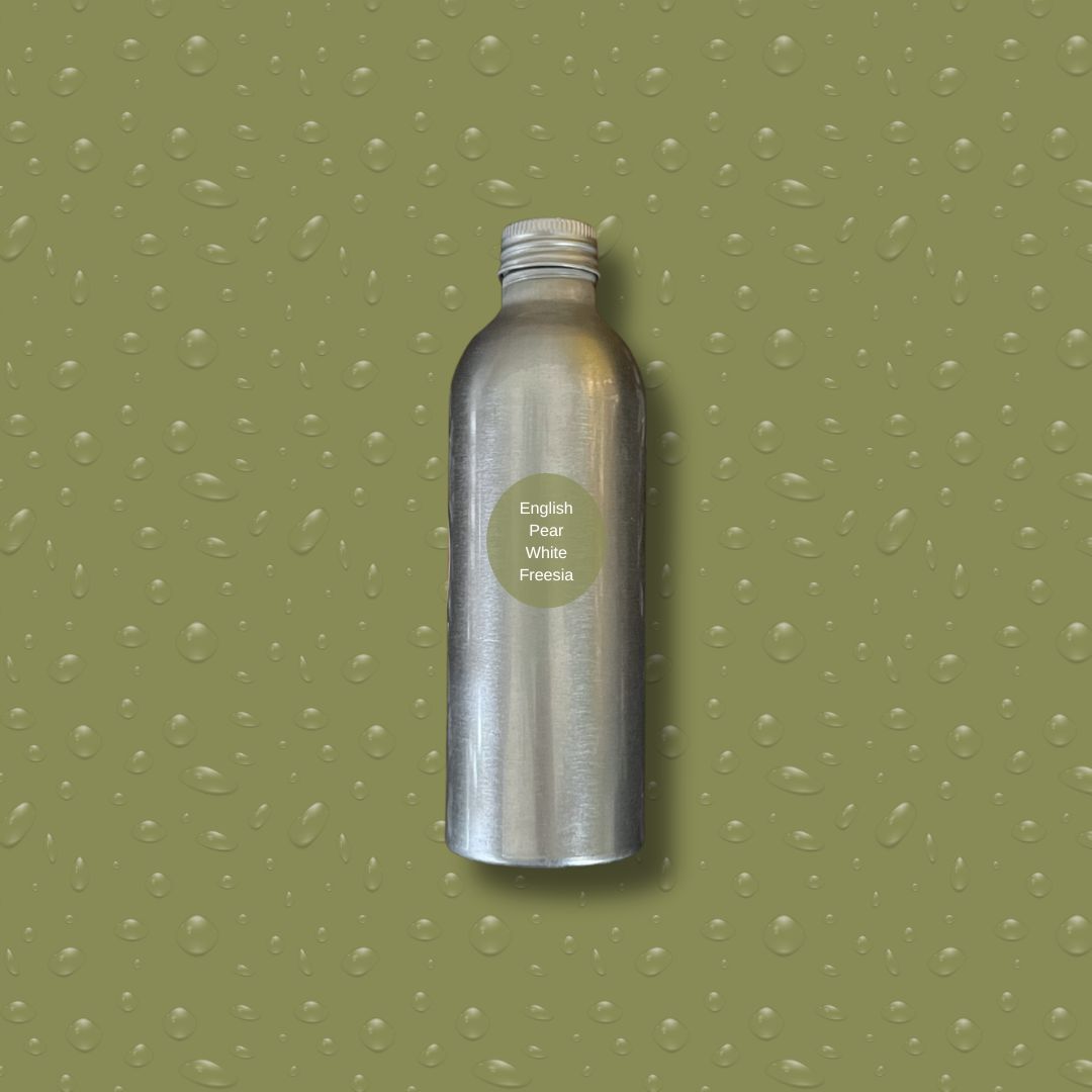 Silver bottle with reeds on a green textured background