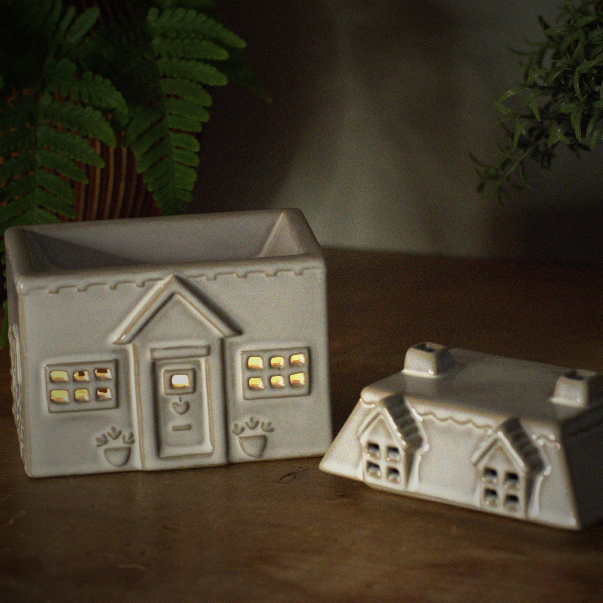 Ceramic house style wax burner with tealight burning inside
