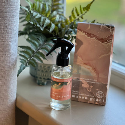 'Mason Grant' Moroccan Almond, Amber and Cedar Room Spray bottle and box on windowsill with plant