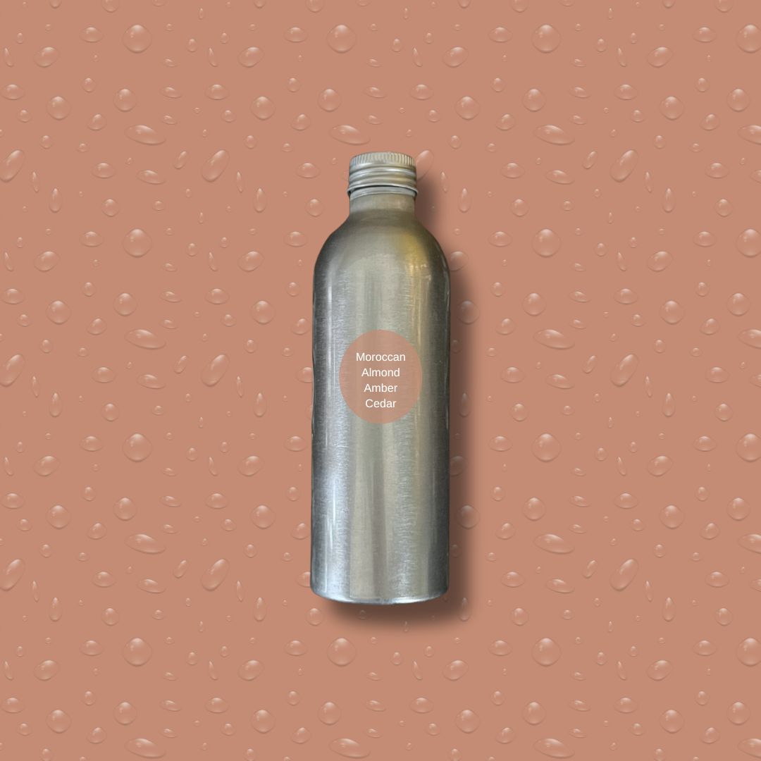 Silver bottle with reeds on a peach textured background