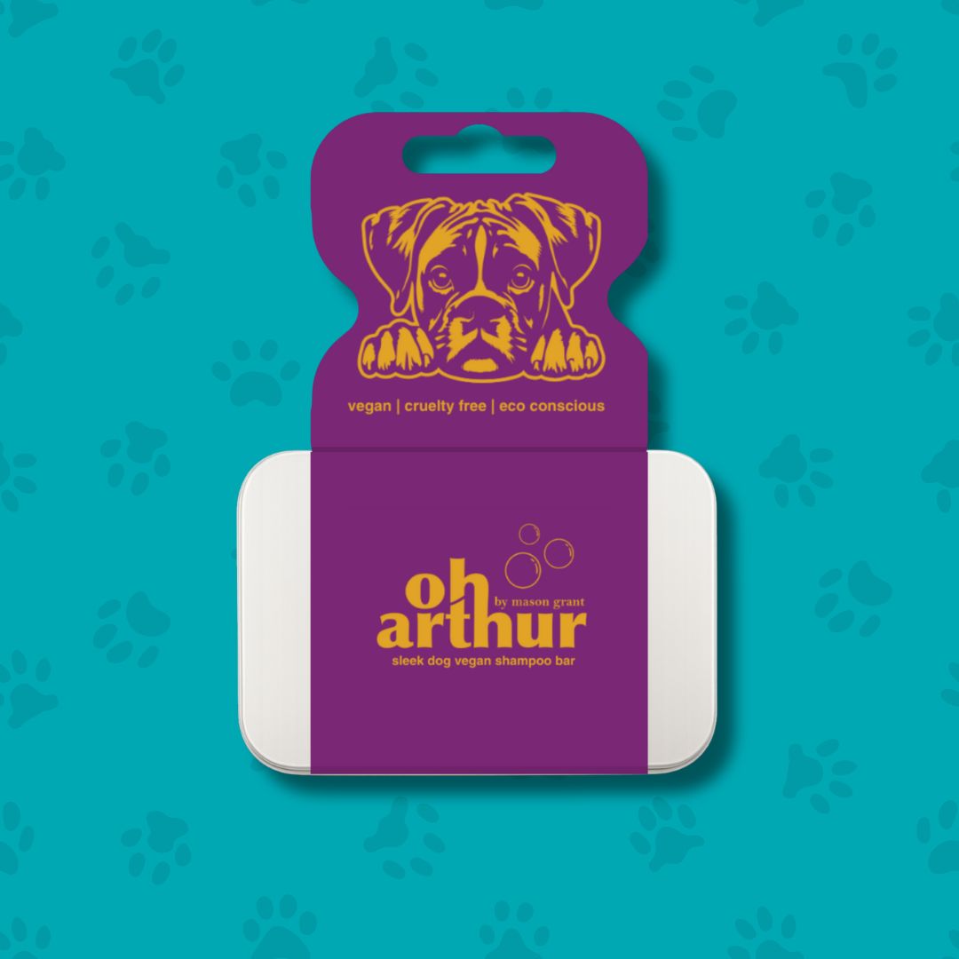 Dog shampoo bar with purple packaging featuring a dog illustration on a teal background with paw prints.