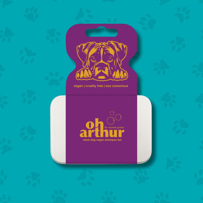 Dog shampoo bar with purple packaging featuring a dog illustration on a teal background with paw prints.