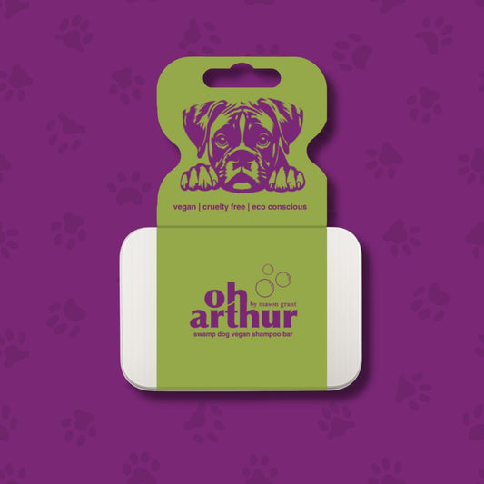 Dog shampoo bar packaging with 'Oh Arthur' branding on a purple background with paw prints.
