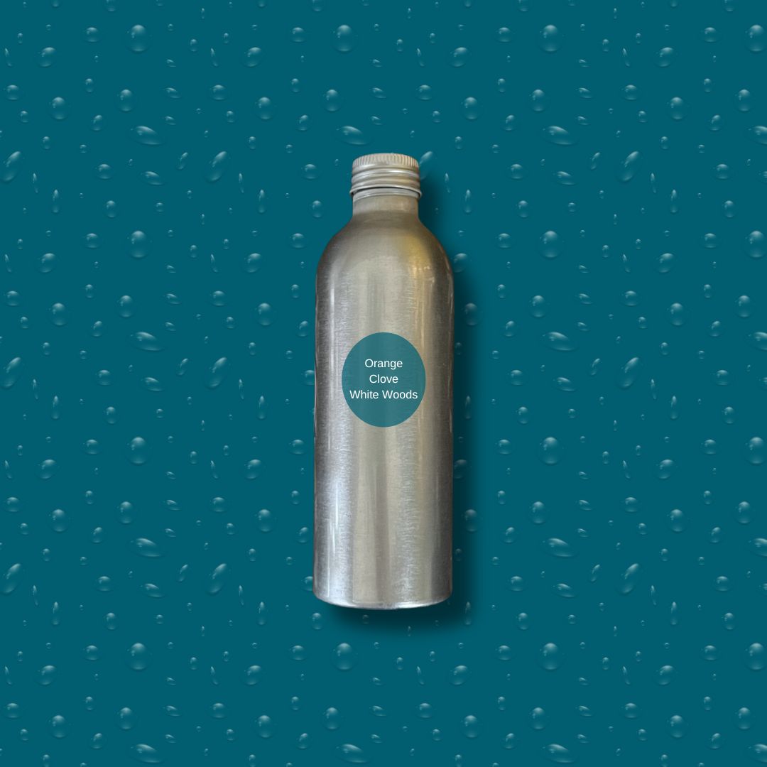 Silver bottle with reeds on a blue textured background