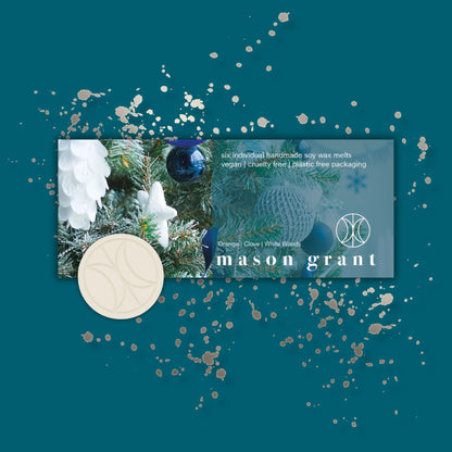 'Mason Grant' Orange, Clove and White Woods Wax Melts on blue background