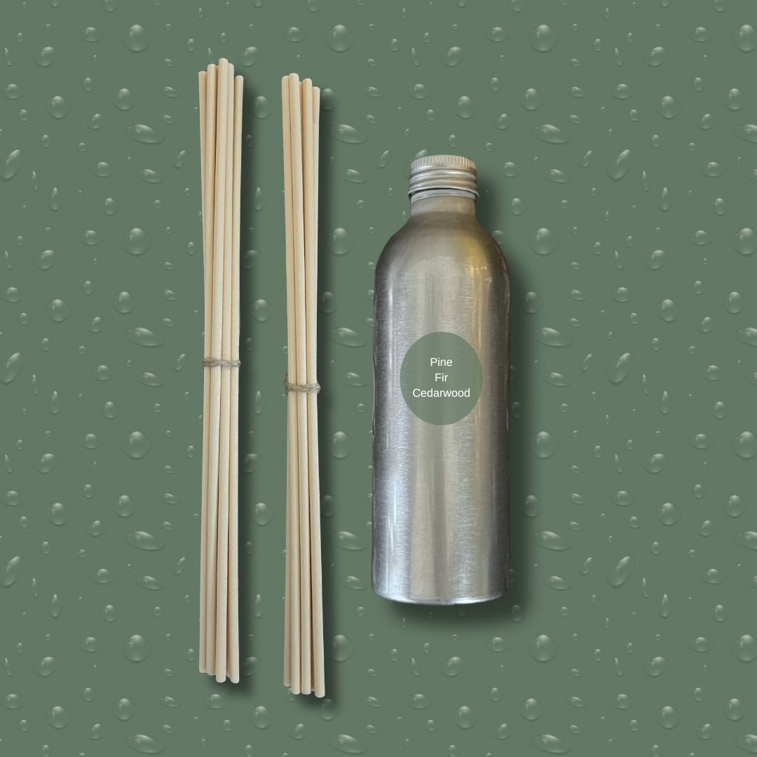 Silver bottle with reeds on a green textured background