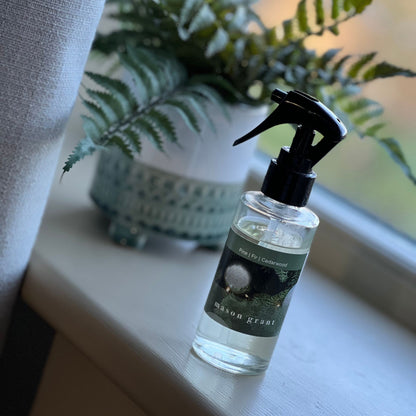 'Mason Grant' Pine, Fir and Cedarwood Room Spray bottle and box on windowsill with plant