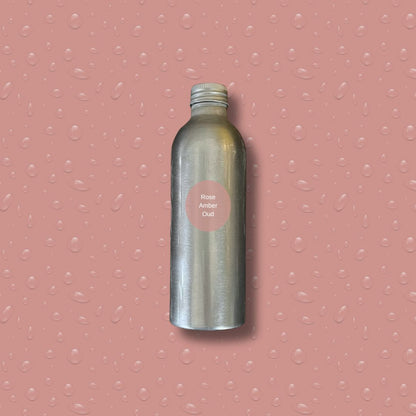 Silver bottle with reeds on a pink textured background